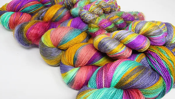 Colorful skeins of yarn on a white background