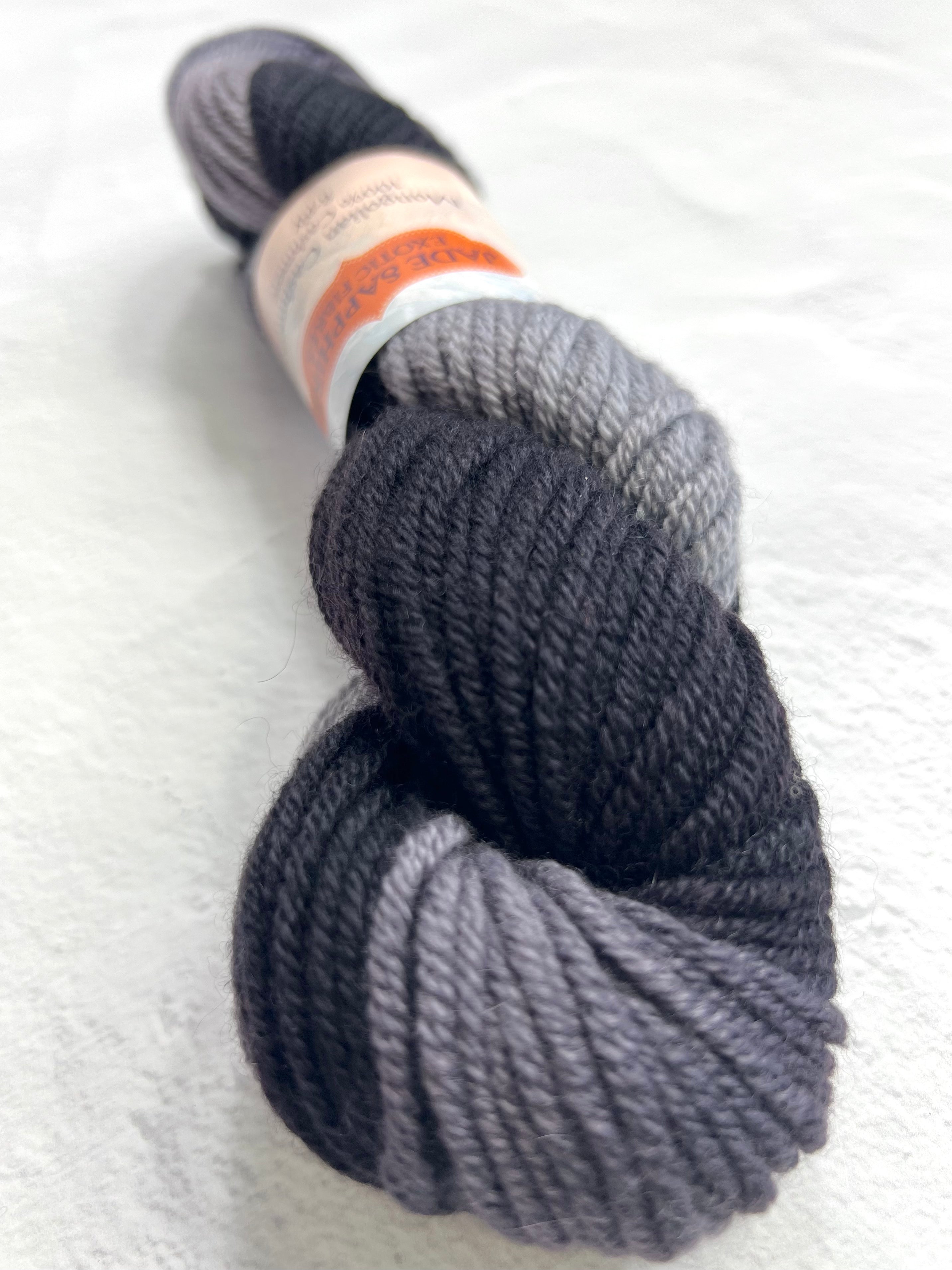 Black Jade Sapphire 8 Ply Cashmere Yarn shown in a skein, highlighting its soft texture and luxurious quality.