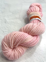 Pink Jade Sapphire 8 ply cashmere yarn skein showing soft, luxurious cashmere fibers ideal for knitting or crochet projects.