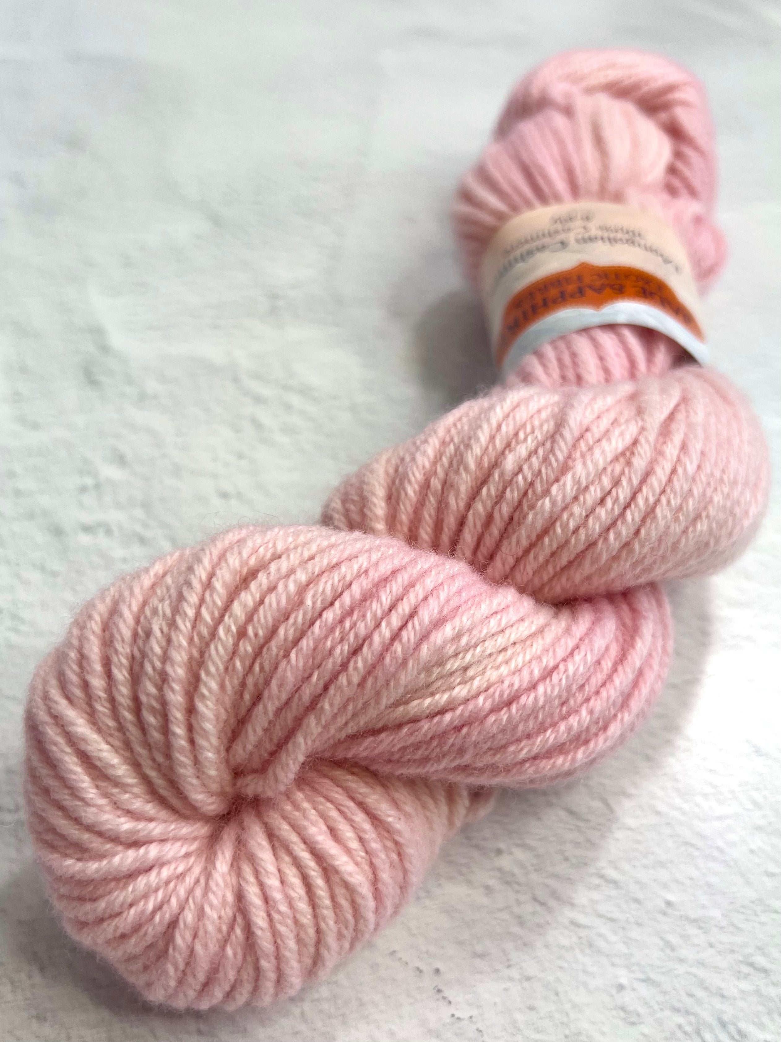 Pink Jade Sapphire 8 ply cashmere yarn skein showing soft, luxurious cashmere fibers ideal for knitting or crochet projects.
