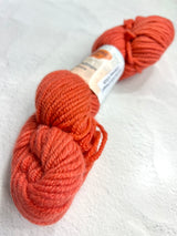 Jade Sapphire Cashmere 8 Ply Cashmere Yarn in vibrant blood orange color, showcasing soft, luxurious fiber and smooth texture.