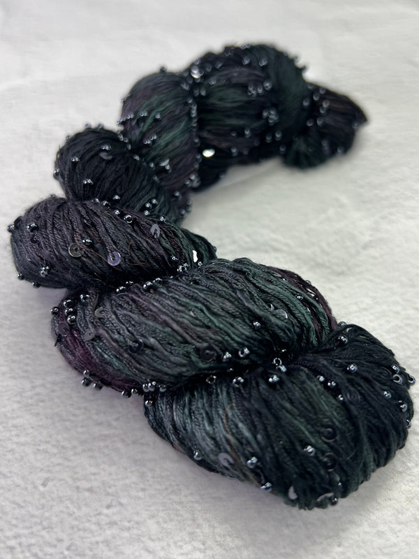 Beaded silk and sequins yarn from Artyarns' Beaded Silk & Sequins Light (H Series) with shiny embellishments and delicate beading.