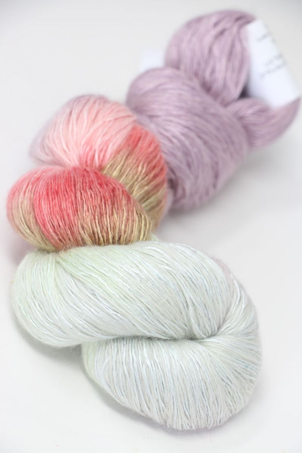 Soft Artyarns Ensemble Light cashmere yarn in F Series colors, showing multiple vibrant yarn skeins with rich textures.