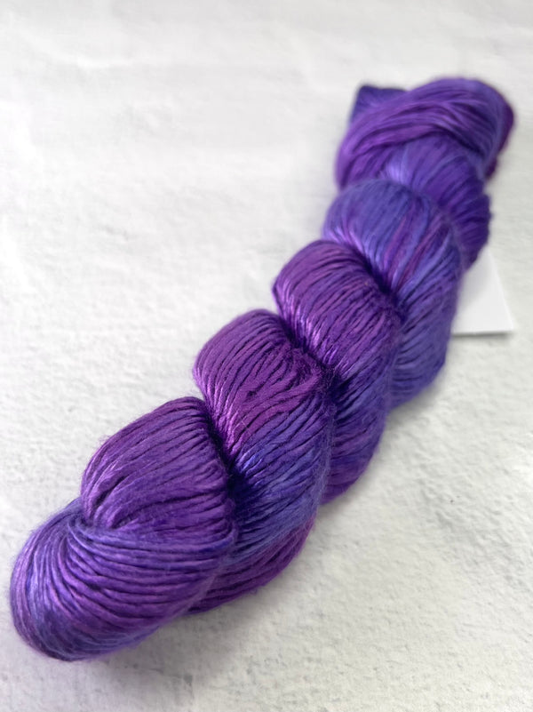 Close-up of Artyarns Regal Silk Yarn H Series, showcasing vibrant silk fiber with shiny, textured highlights for knitting or crochet projects.