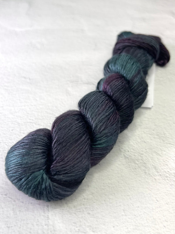 Close-up of Artyarns Regal Silk Yarn H Series, showing vibrant silk fibers and textured highlights in a natural fiber bundle.