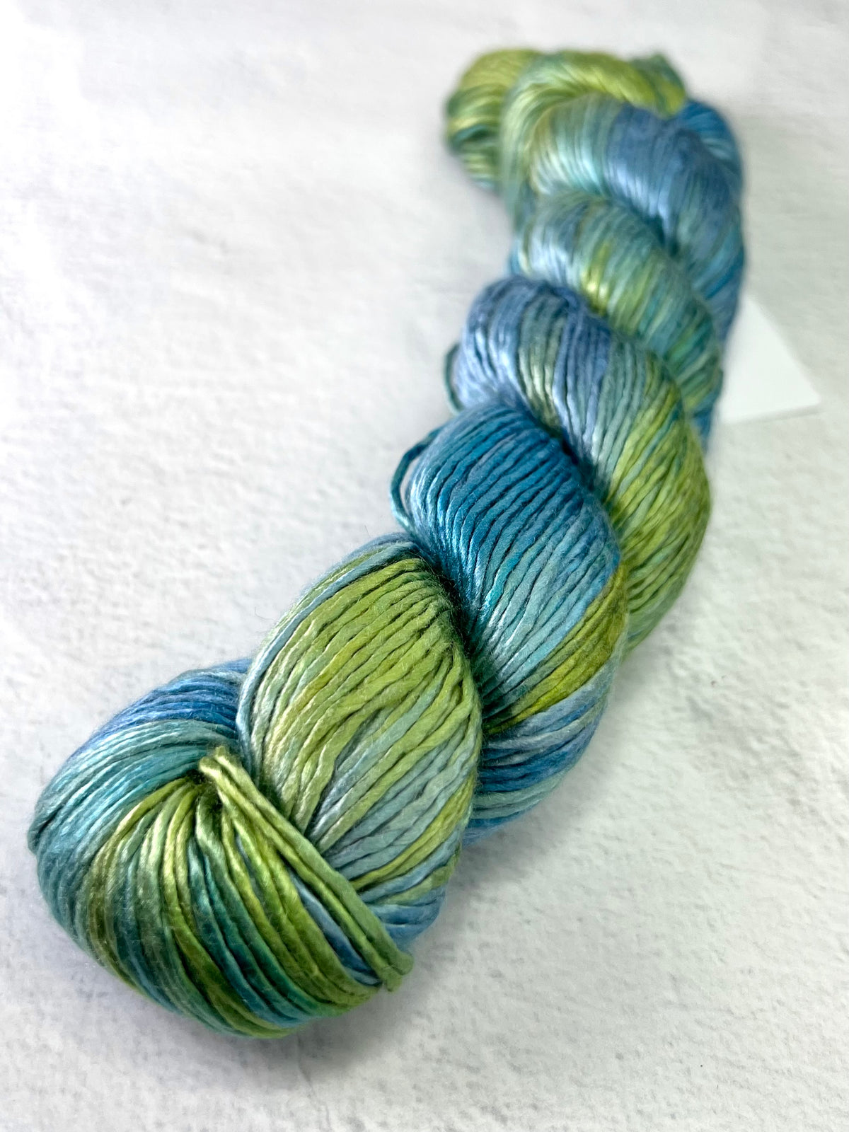 Close-up of Artyarns Regal Silk Yarn in H Series, showcasing its smooth silk texture and vibrant color highlights.