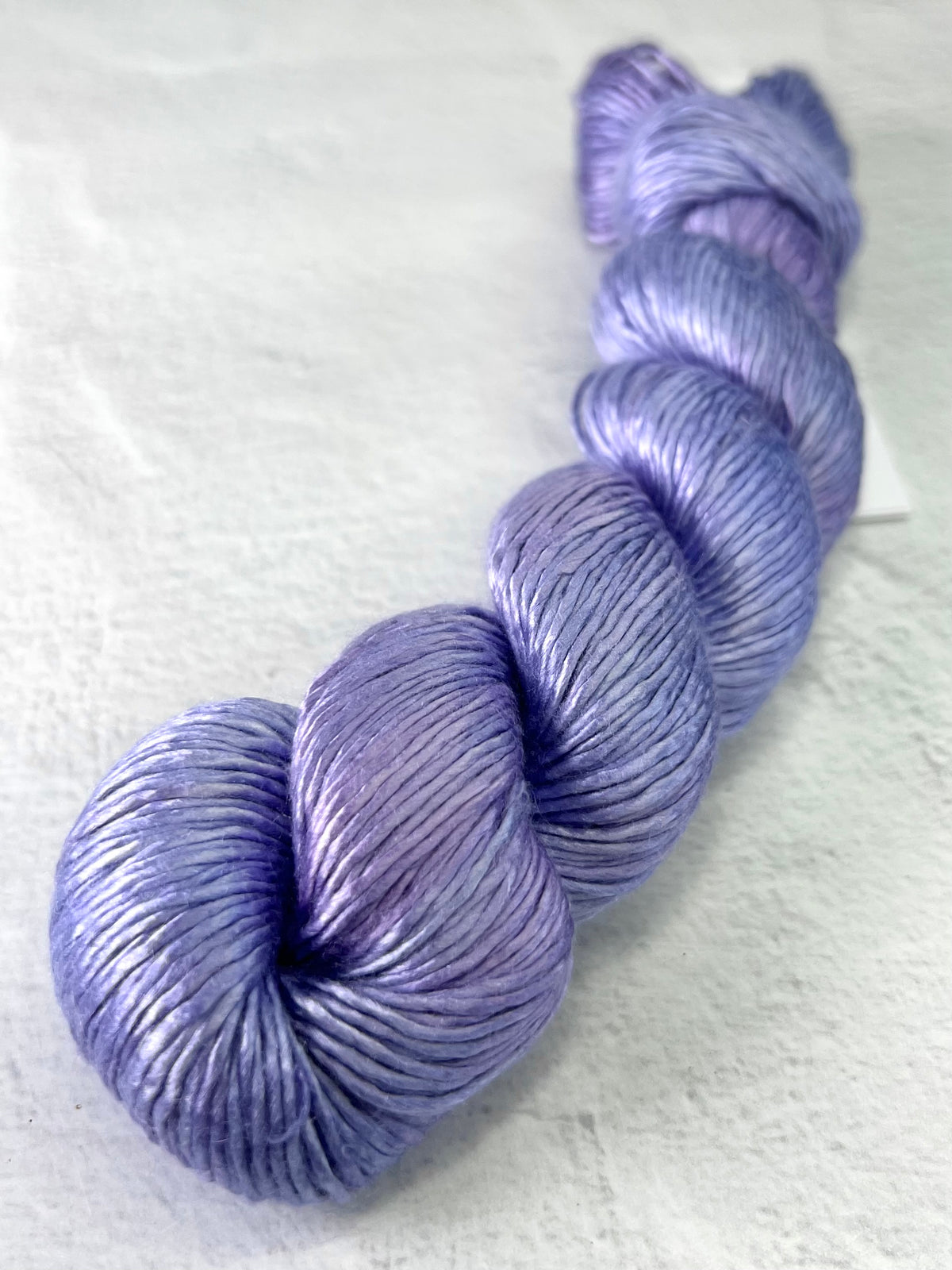 Close-up of Artyarns Regal Silk Yarn H Series in vibrant highlights, showcasing the smooth, glossy silk texture and rich color details.