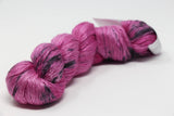 Colorful skein of Artyarns Ensemble Light yarn from the Cosmic Colors series, showcasing vibrant, multi-hued fiber for knitting or crochet.