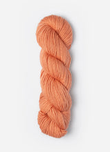 Blue Sky Fibers Suri Merino alpaca and merino yarn in a soft blue color, showcasing a close-up of the fiber texture.