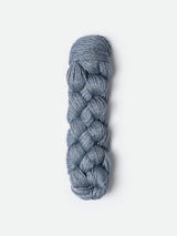 Blue Sky Fibers Metalico alpaca yarn in a soft blue color, showing the smooth, shiny texture of the fiber.