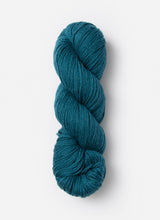 Blue Sky Fibers Sweater Worsted Superwash knitting yarn in soft blue, featuring a close-up of the wool and cotton blend fibers.