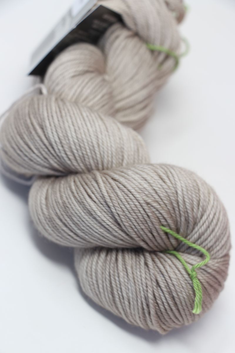 Close-up of madelinetosh Vintage merino wool yarn in antique lace color, showcasing its soft texture and rich hue.