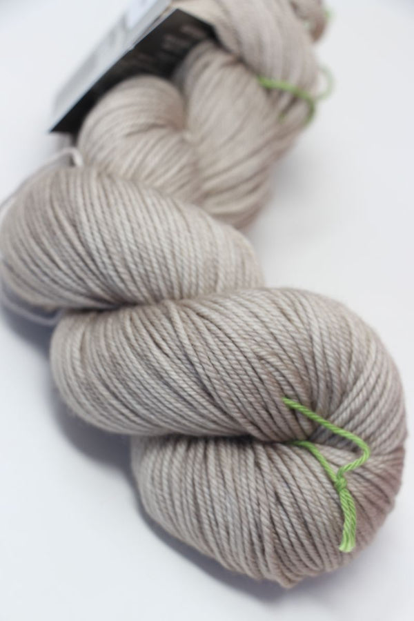 Close-up of madelinetosh Vintage merino wool yarn in antique lace color, showcasing its soft texture and rich hue.