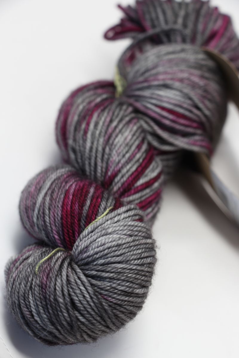 Black Madeline Tosh Vintage Merino Wool Yarn skein, soft and textured, perfect for knitting or crocheting projects.