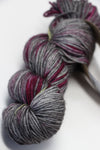 Black Madeline Tosh Vintage Merino Wool Yarn skein, soft and textured, perfect for knitting or crocheting projects.