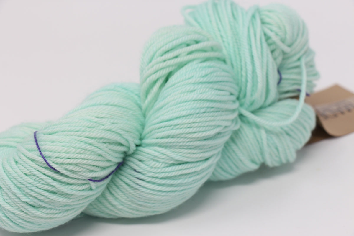 Madelinetosh Tosh DK yarn in Havana colorway, soft wool blend with rich, warm brown hues and subtle color variations.