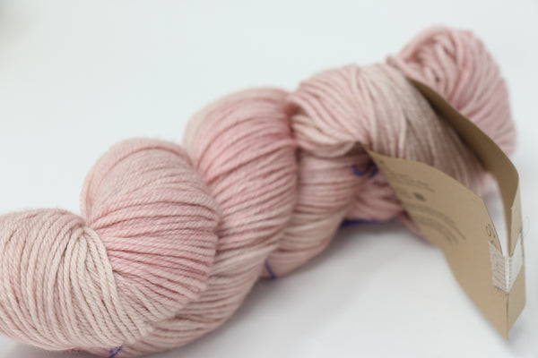 Soft, colorful skein of Madelinetosh Tosh DK yarn in a Scout colorway, showcasing its smooth texture and vibrant dyeing.