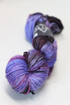Madelinetosh Tosh DK yarn in Strange Arcade colorway, soft wool blend, skein with vibrant multicolor dye pattern.