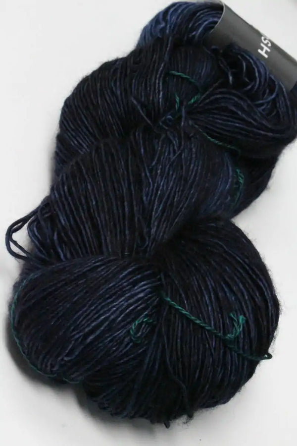 Light blue madelinetosh Tosh DK yarn ball, soft and textured wool in Ink color, ideal for knitting and crochet projects.