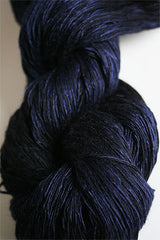 Colorful skein of Artyarns Ensemble Light yarn in Cosmic Colors H Series, showcasing vibrant, textured yarn fibers.
