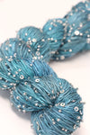 Beaded silk and sequins yarn from Artyarns' Beaded Silk & Sequins Light H Series, featuring shiny beads and delicate silk fibers.