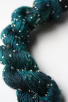 Beaded silk and sequins yarn by Artyarns, light H series, showcasing shimmering beads and delicate fiber texture.
