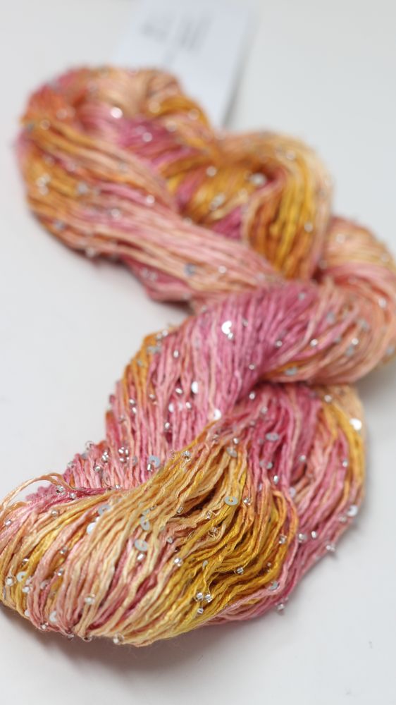 Beaded silk and sequins yarn by Artyarns, light H Series with shimmering beads and sequins, showcasing its elegant texture and sparkle.