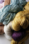 Artyarns Ensemble Glitter Light yarn in Queen Blue Silver with cosmic colors and stonewash shades, showcasing vibrant, shimmering fibers.