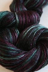 Soft silk yarn from Artyarns Silk Essence Lace collection, showcasing delicate, shiny silk strands for knitting and crochet projects.