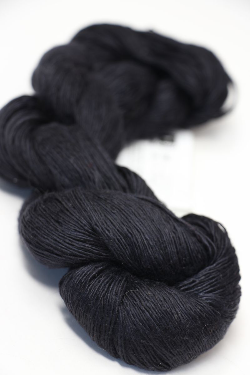 Soft, luxurious silk yarn from Artyarns Silk Essence Lace in a delicate lace pattern, showcasing its smooth texture and elegant sheen.