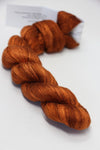 Soft pink Artyarns Silk Essence Lace silk yarn skein with delicate sheen and fine texture for luxurious knitting or crochet projects.