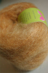 Be Sweet medium brushed mohair yarn in wheat color, showcasing soft, textured fibers ideal for knitting or crochet projects.