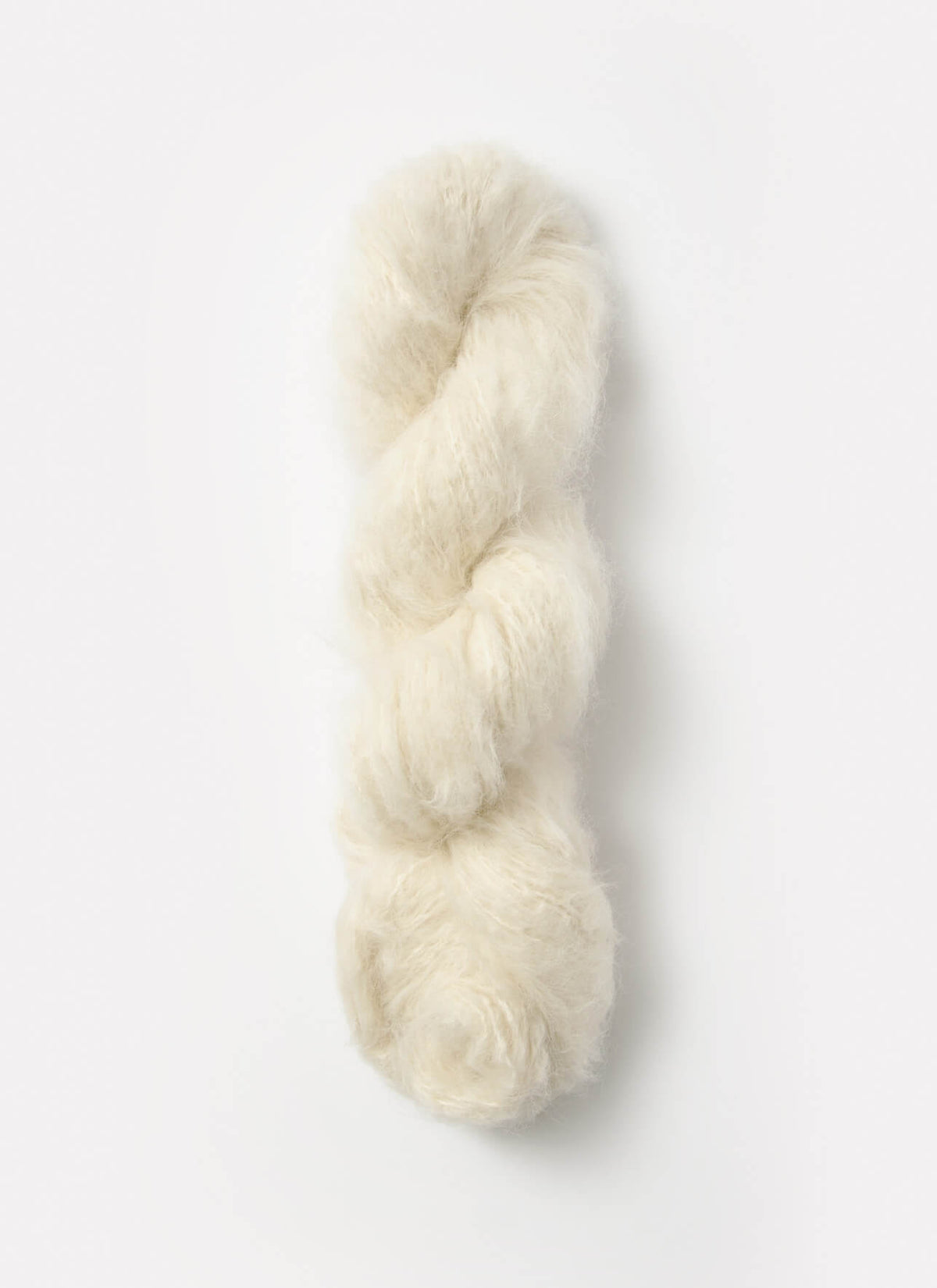 Blue Sky Fibers Brushed Suri alpaca yarn in soft blue color, showing thick, plush spun fiber with a smooth texture.