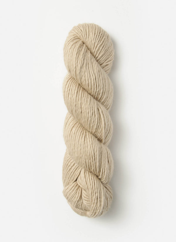 Blue Sky Fibers Suri Merino alpaca yarn in soft blue, showcasing the smooth, luxurious fiber with a close-up of the spun strand.