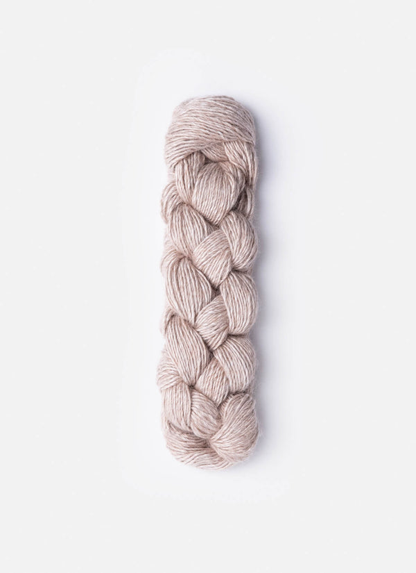 Blue Sky Fibers Metalico alpaca yarn in soft blue, showcasing its smooth, shiny texture and rich color.