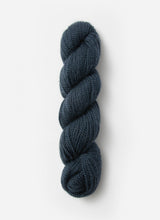 Blue Sky Fibers Baby Alpaca Sport Weight solid alpaca yarn in a soft blue color, displaying the yarn skein with smooth texture.