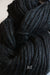 Cascade Yarns Magnum bulky yarn in a rich jet black color, shown in a close-up of soft, thick yarn strands.