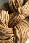 Close-up of Cascade Yarns Magnum bulky yarn in vibrant color, showcasing its thick, cozy texture suitable for warm knitting projects.