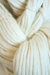 Cream-colored Cascade Yarns Magnum bulky yarn ball showcasing thick, soft wool yarn perfect for cozy knitting projects.