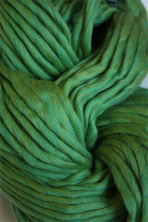 Cascade Yarns Magnum bulky yarn in lime green, showing thick, soft yarn strands perfect for cozy knitting projects.