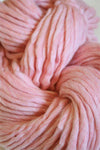 Cascade Yarns Magnum bulky yarn in strawberries and cream color, shown in a close-up view of the textured fiber.