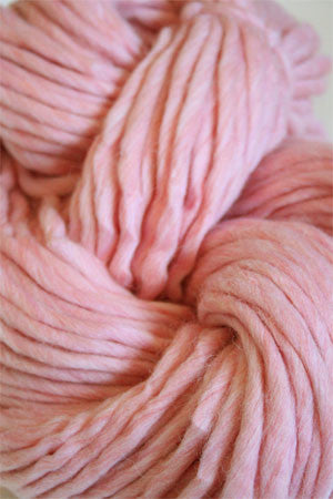 Cascade Yarns Magnum bulky yarn in strawberries and cream color, shown in a close-up view of the textured fiber.