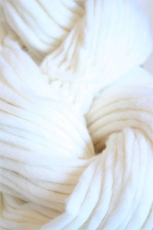 White Cascade Yarns Magnum bulky yarn ball, showcasing soft, thick fiber for knitting or crochet projects.