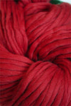 Cascade Yarns Magnum bulky yarn in regal red, showcasing thick, soft yarn strands suitable for cozy knitting projects.