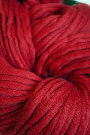 Cascade Yarns Magnum bulky yarn in regal red, showcasing thick, soft yarn strands suitable for cozy knitting projects.