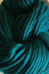 Cascade Yarns Magnum bulky yarn in a vibrant blue color, showcasing thick, soft fiber suitable for cozy knitting projects.