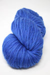 Cascade Yarns Magnum bulky yarn in a rich cobalt heather color, displayed in a close-up shot showing its thick, soft texture.