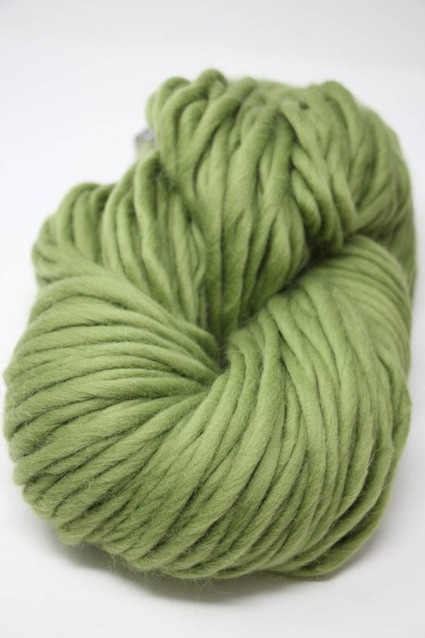 Cascade Yarns Magnum bulky yarn in turtle green, showing thick, soft yarn strands suitable for cozy knitting projects.