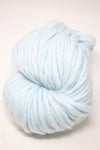 Cascade Yarns Magnum bulky yarn in vibrant blue color, shown in a close-up of the soft, thick fiber texture.