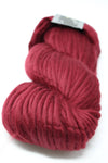 Cascade Yarns Magnum bulky yarn in burgundy color, showcasing thick, soft yarn strands suitable for knitting and crochet projects.
